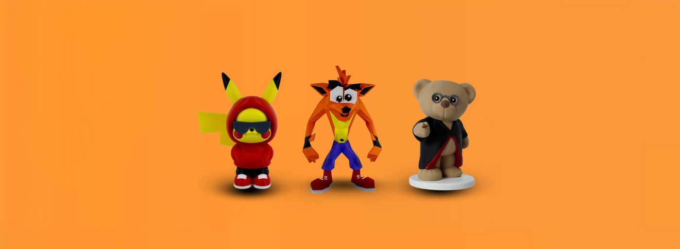 Three colorful figurines on an orange background